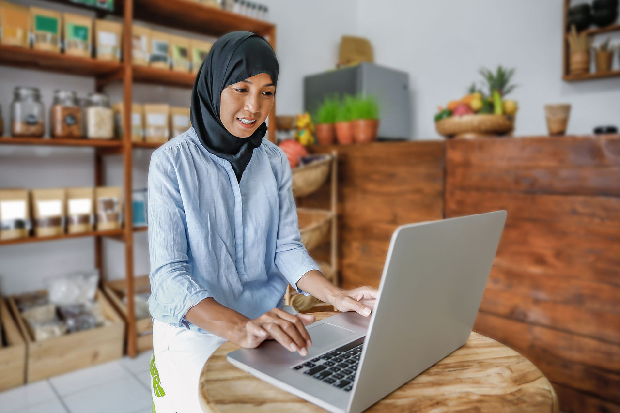 Shot of a local business owner happy on computer